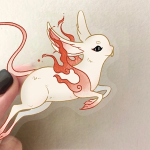Close-up of a transparent PET sticker featuring an ancient white mythical beast with red flames