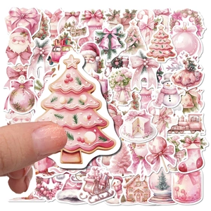 Close-up of pink Christmas watercolor stickers held in hand for scale and detail