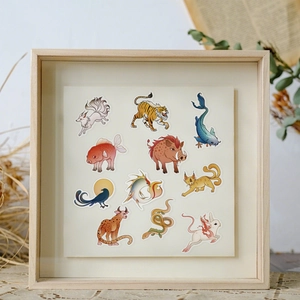 Artistic detail of mythical creature stickers featuring dragon and fox in a wooden frame