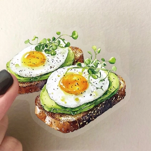 Macro detail of waterproof watercolor avocado toast sticker on a clear PET material