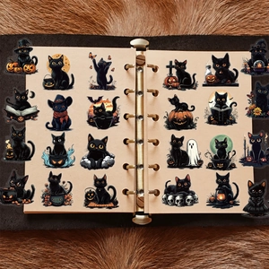 Detailed view of Halloween black cat stickers displayed in a vintage journal notebook