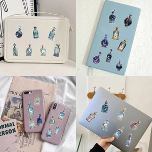 Macro view of magic potion bottle stickers with moon and star patterns on laptop and notebook