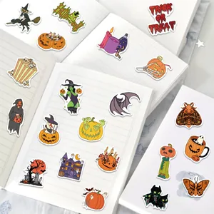 Detail of cartoon Halloween stickers on a notebook with pumpkin and ghost designs