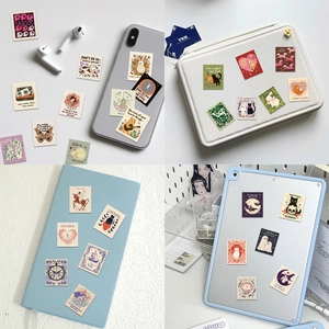 Detail showing aesthetic motivational stickers on smartphone and laptop covers