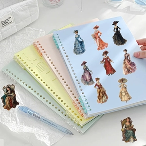 Detailed view of vintage Victorian lady stickers on Morandi color spiral notebooks