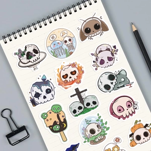 Close-up of waterproof cartoon gothic skull stickers on a notebook for Halloween decor