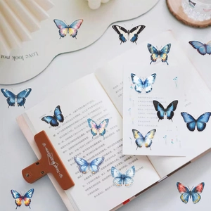 Macro detail of vintage butterfly stickers in various colors on an open book page