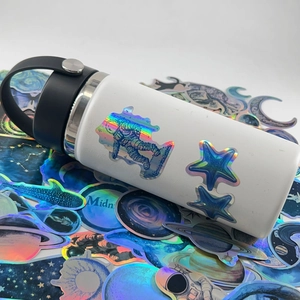 Holographic astronaut space stickers applied on white vacuum flask with laser effect