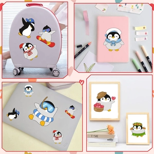 Cartoon penguin stickers shown as decorative decals on luggage and laptop surfaces