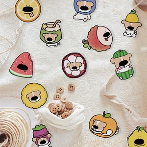 Close-up of cute fruit dog stickers on linen fabric with decorative wooden buttons