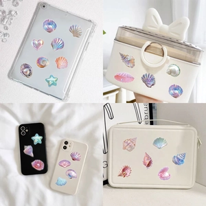 3D iridescent seashell stickers with pearls shown on phone cases and bags
