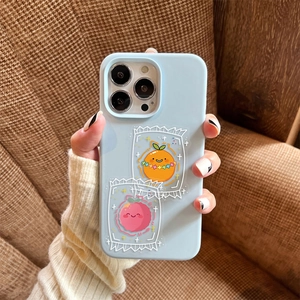 Detail showing cute fruit stickers on a light blue phone case in a lifestyle setting