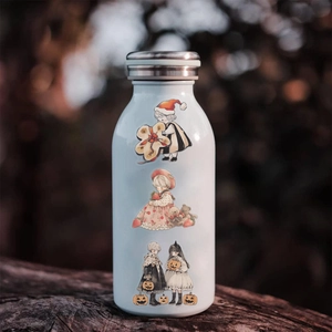 Waterproof cartoon stickers shown on a white stainless steel bottle in a forest setting