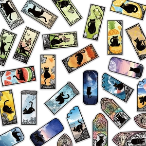 Close-up of decorative PET stickers featuring various cute black cats and colorful art scenes