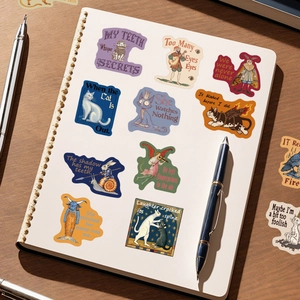 50 Medieval surrealist art stickers with cat and fish-man motifs on a notebook