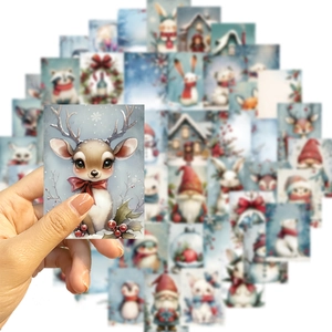 Close-up of waterproof Christmas stickers with watercolor reindeer and snowman patterns