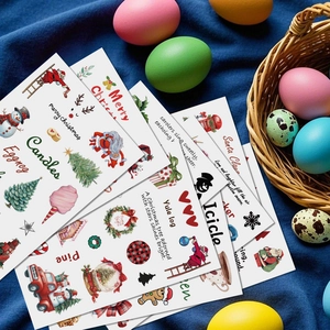 Close-up of waterproof PVC Christmas stickers with Santa and reindeer on blue velvet fabric