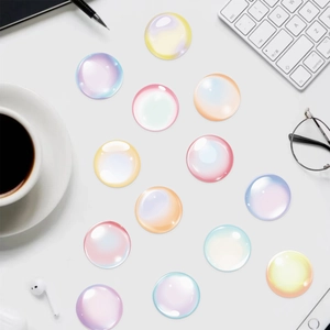 Close-up of translucent 3D bubble stickers with colorful gradient on a desk