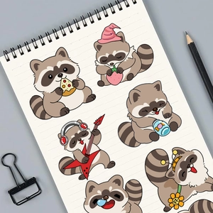 Close-up of cute cartoon raccoon stickers with guitar and pizza on a notebook