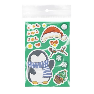 Macro view of Christmas cartoon stickers packaging with penguin and holiday elements