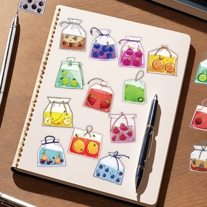 Close-up of fruit tea bag stickers on an open notebook with realistic colorful details