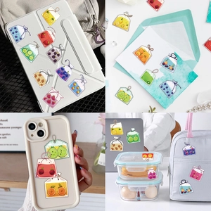 Detailed view of aesthetic fruit tea stickers applied to a tablet case and stationery