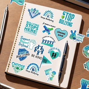 Close-up of anti-bullying stickers on a notebook with Be Kind and Stop Bullying slogans