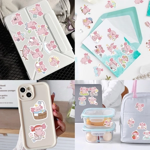 Detail showing cute pink axolotl stickers applied on iPad, phone case, and daily items