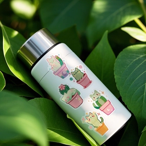 Water bottle detail showing cute cat cactus PET stickers on a white stainless steel cup
