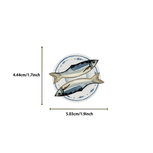 Detail showing cartoon sardine sticker with fish on porcelain plate, sized 1.9 by 1.7 inches