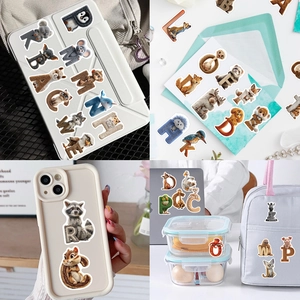 Lifestyle view showing 3D animal alphabet stickers on laptop, phone case and backpack