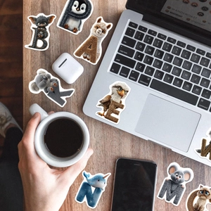Close-up of 3D animal alphabet stickers featuring vibrant cartoon designs on a wooden desk