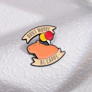 Cartoon enamel capybara pin badge with balloons and Don't Worry Be Cappy text