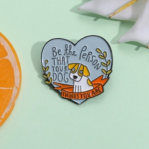 Cute heart-shaped enamel pin with cartoon dog and inspirational quote on blue background