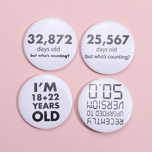 Set of four minimalist white tinplate badges with humorous black age-related typography