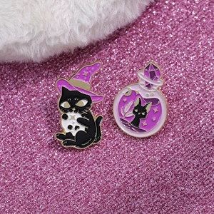 Cute black cat enamel pin set with purple witch hat and potion bottle on glittery background
