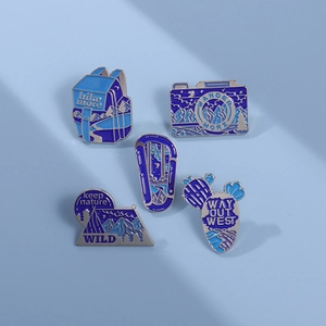 Five-piece blue enamel lapel pin set featuring outdoor hiking and camera travel themes