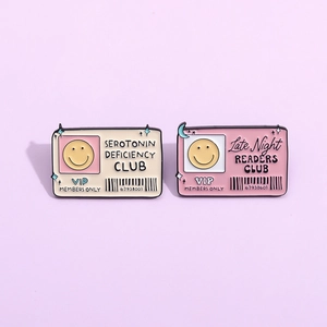 Enamel pins set featuring Serotonin Deficiency and Late Night Readers Club designs