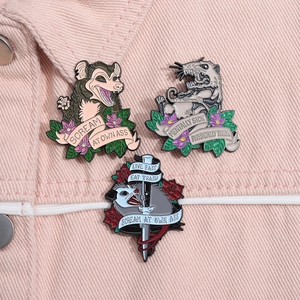 Three creative opossum enamel pins with funny phrases pinned on a pink denim jacket
