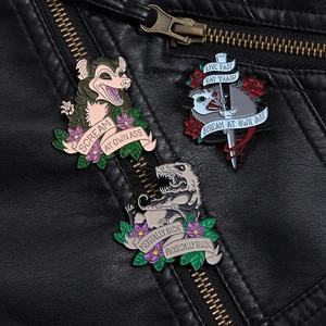 Detailed macro view of three opossum enamel pins on a black leather jacket background