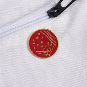 Red and gold geometric circle enamel pin with petri dish science laboratory design
