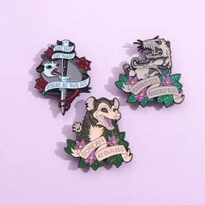 Three enamel pins featuring funny opossum memes on a lavender background background