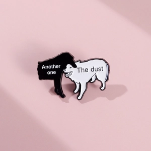 Detail of enamel pin with two dogs and Another One Bites The Dust text design