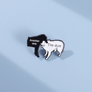 Detailed macro view of the enamel dog brooch with 'Another one bites the dust' text