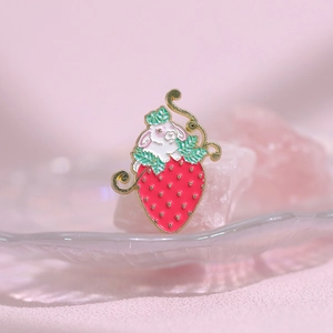 Cute white bunny in red strawberry enamel pin badge accessory with gold metal outlines