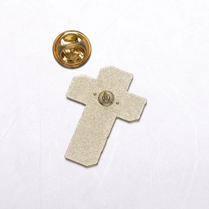 Detail view showing the golden metal back with butterfly pin clutch for secure fastening