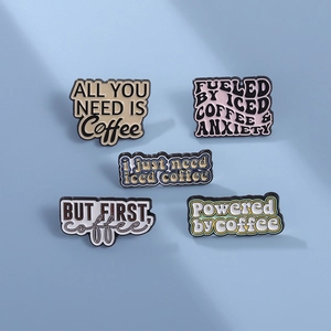 Set of five creative coffee enamel pins with unique typography on light blue background