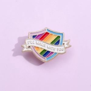 Rainbow shield enamel pin with I'll Walk With You text ribbon on purple background