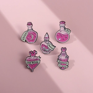 Detailed view of five pink magic potion enamel pins featuring moon and heart elements