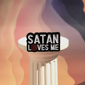 Gothic metal enamel pin with Satan Loves Me text and red pentagram on a classic white pillar
